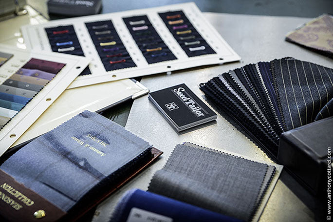 Sélection de tissus pour costumes de marié, avec des échantillons de rayures, de laines et de couleurs unies. Un aperçu du choix de matières disponibles pour un costume de cérémonie haut de gamme